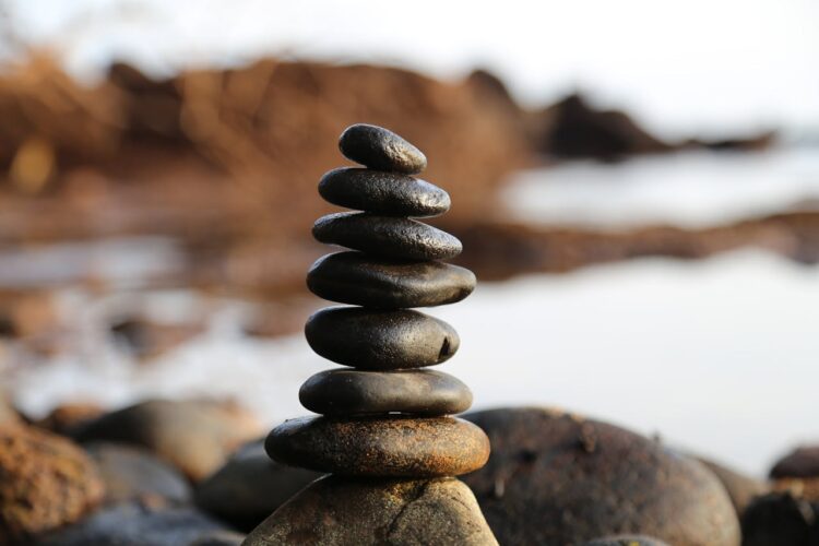 A pile of stones balancing on a beach