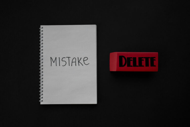 A notebook with "mistake" written in it and an eraser with "delete" written on it in marker