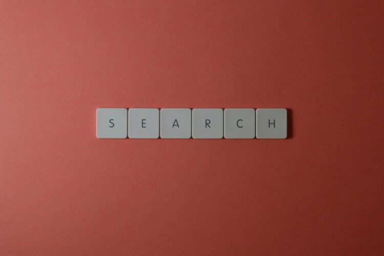 Tiles on a red background spelling out the word "search".