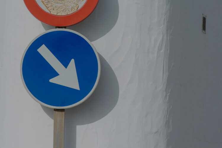 A street sign pointing diagonally down to the right